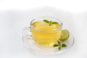 Mint or basil tea in a glass cup. Mint or basil leaves, herbs tea and mint leaves tea cup served in a restaurant or teahouse tea. Selective focus.