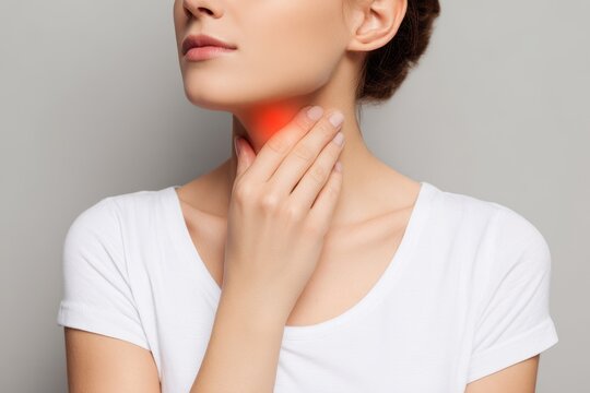 Woman self examining her thyroid Close up of neck with red mark Thyroid issues goiter hyperthyroidism hypothyroidism tumors cancer Health awareness