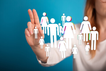 Hand pointing at floating digital people icons, symbolizing connection, teamwork, and community....