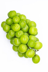 bunch of green large grapes on a white background close-up top view