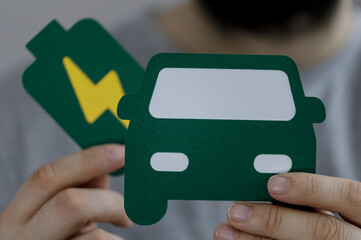 Conceptual image of an electric car and battery icon representing sustainable transportation, green...
