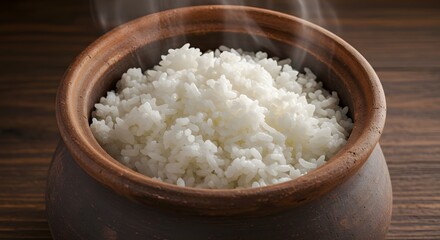 Steaming bowl of white rice in a rustic wooden pot for culinary content