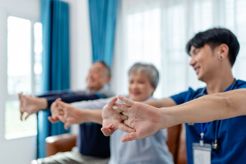 Obraz premium focus on hands of physiotherapist, senior couple practices muscle strength exercises arms and hands. home caregiver nurse visit retire couple for health check up recovery process medical service