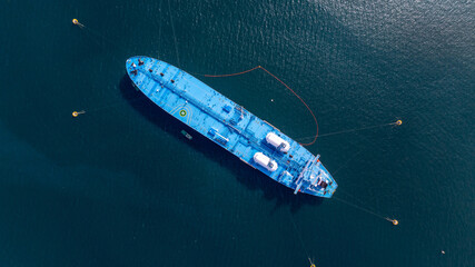 Aerial view oil ship tanker vessel loading and unloading in oil terminal station refinery, Global...