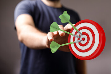 Image of a man hitting the target with darts, perfect for illustrating achievement, strategy, and...