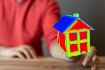 A vibrant 3D model of a house in hand, symbolizing homeownership, investment, and dreams. Perfect...