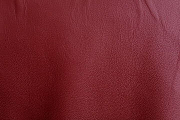 Fototapeta premium Red leather texture background, perfect for use in various design projects. Ideal for backgrounds, textures, and abstract design concepts. Offer