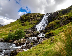 A cascading waterfall surrounded by lush green hillside vegetation