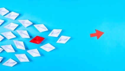 Obraz premium Unique Red Paper Boat Leading White Boats on Blue Background
