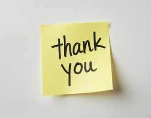 Yellow sticky note with Thank You written by hand in black marker. Simple message conveys gratitude and appreciation. Isolated on white.