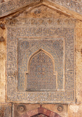 Generated Islamic architectural wall panel with intricate Arabic calligraphy, floral and geometric patterns in blue and gold tones, showcasing sacred art and cultural heritage. Pushkar, India