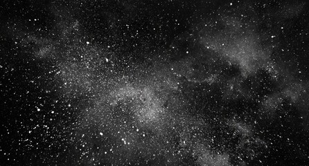 Abstract black background with scattered white particles resembling dust or stars
