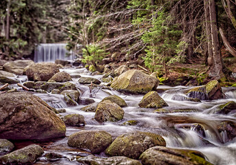 Long Waterfall in Karpacz Forest, Karkonosze Mountains, Poland. 