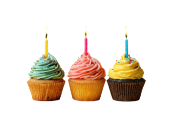 Three cupcakes frosted in pastel colors, with lit candles, set against a dark background