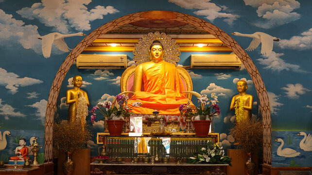 India, Bihar, Bodh Gaya, The Beautiful Statue of Lord Buddha With Dramatic Clouds Around in Buddhist Monastery.  