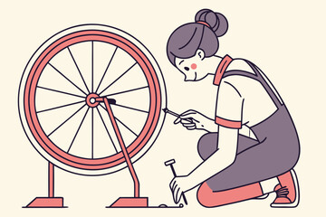 Woman repairing bicycle wheel with tools in workshop