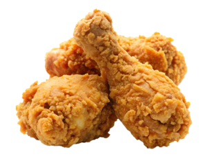 Crispy golden brown fried chicken pieces piled high against a stark black background for a delicious food concept