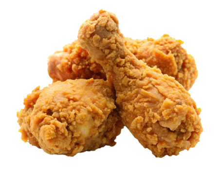 Crispy golden brown fried chicken pieces piled high against a stark black background for a delicious food concept