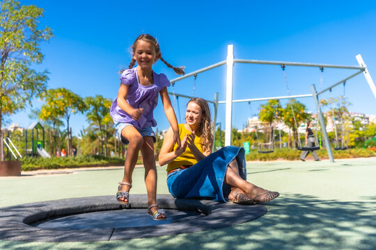 Mother and daughter playing outdoors enjoying summer fun