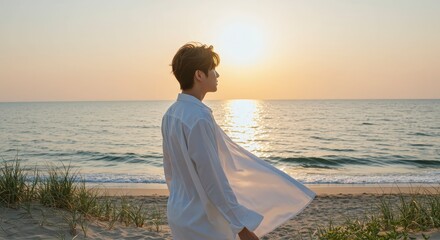 Man on beach at sunset silhouette against ocean and sun outdoor scene