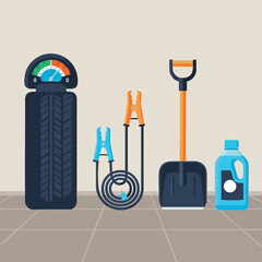 Essential car maintenance and winter preparation tools including a tire with pressure gauge, jumper cables, snow shovel, and fluid bottle.