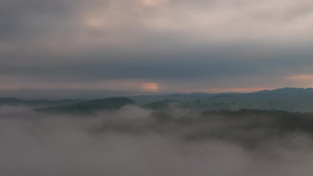 Drone Pullback Over Misty French Hills in Soft Morning Light