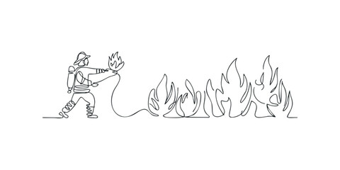 Obraz premium Firefighter spraying water on a line of flames