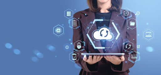 Businesswoman holding tablet with cloud backup service icons and