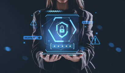 Woman holding laptop with glowing padlock hologram representing cybersecurity protection concept on...