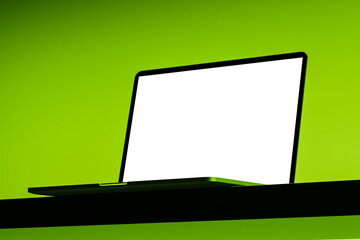 Laptop mockup with blank white screen on green background for tech presentation or display concept...