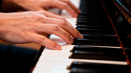 Fototapeta premium Hands Playing Piano Keys Close-up with Motion Blur for Music Learning and Education Content
