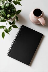 Minimalist workspace with plant, notebook, and ceramic mug