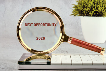 A magnifying glass focuses on the words next opportunity 2026, highlighting the importance of seizing moments for growth against a clean, minimalistic background