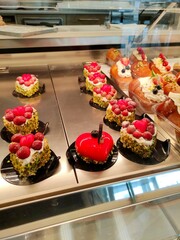 Colorful desserts displayed in a pastry shop showcase  