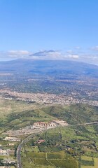 Aerial view of Mount Etna with lush landscape and blue sky  