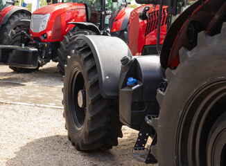 New agricultural tractors displayed in a row.