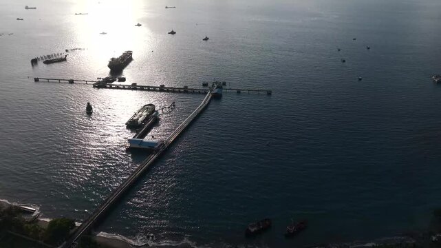 Aerial Drone Shot From Ocean to Oil Storage Tanks, Coastal Industrial Infrastructure and Energy Facility.