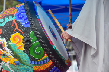 Buddhist monk banging a Buddhist drum