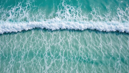 Aerial View of Gentle Waves Crashing on Turquoise Ocean Surface Near Sandy Shore