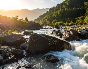 Sunlit river cascading through a rocky landscape, mountains in the distance