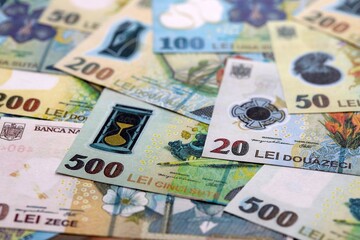 Romanian Leu currency money bills. RON currency banknotes in heap with different denomination close...