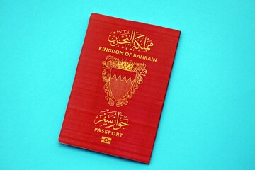 Bahrain passport book on light blue paper background close up. Travel document on blue surface