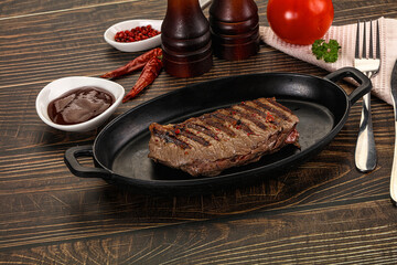 Grilled beef striploin steak with sauce