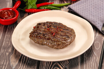 Grilled beef burger cutlet with sauce