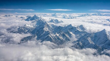 A breathtaking aerial view of snow-capped mountain peaks rising above a sea of clouds, showcasing the majestic and serene beauty of high-altitude landscapes.