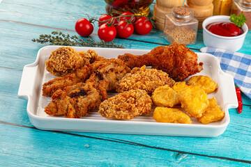 Golden crispy fried chicken mix - wings, drumsticks, nuggets and strips