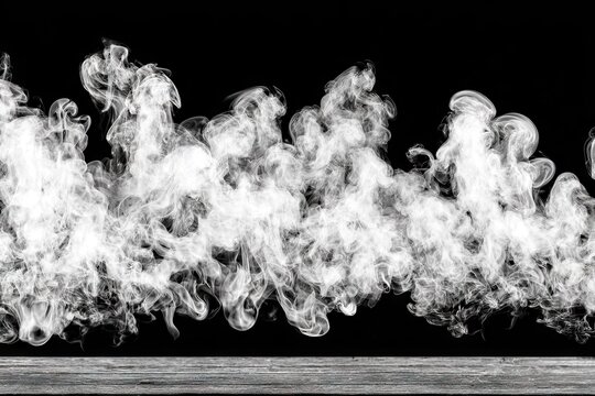 Billowing white smoke rising from a grey surface, on black ground