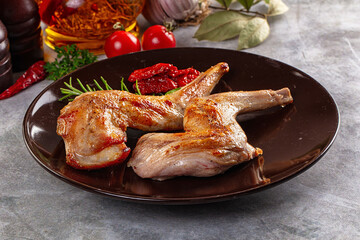 Roasted rabbit leg served rosemary