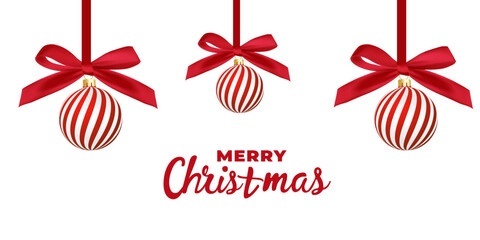Christmas balls Red and white striped hang on red satin ribbon with bow. Xmas background for l festive mood for holiday campaigns, winter celebrations, festive greeting cards, or seasonal marketing of