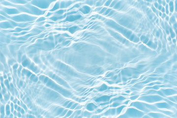 Blue water with ripples on the surface. Defocus blurred transparent blue colored clear calm water surface texture with splashes and bubbles. Water waves with shining pattern texture background.